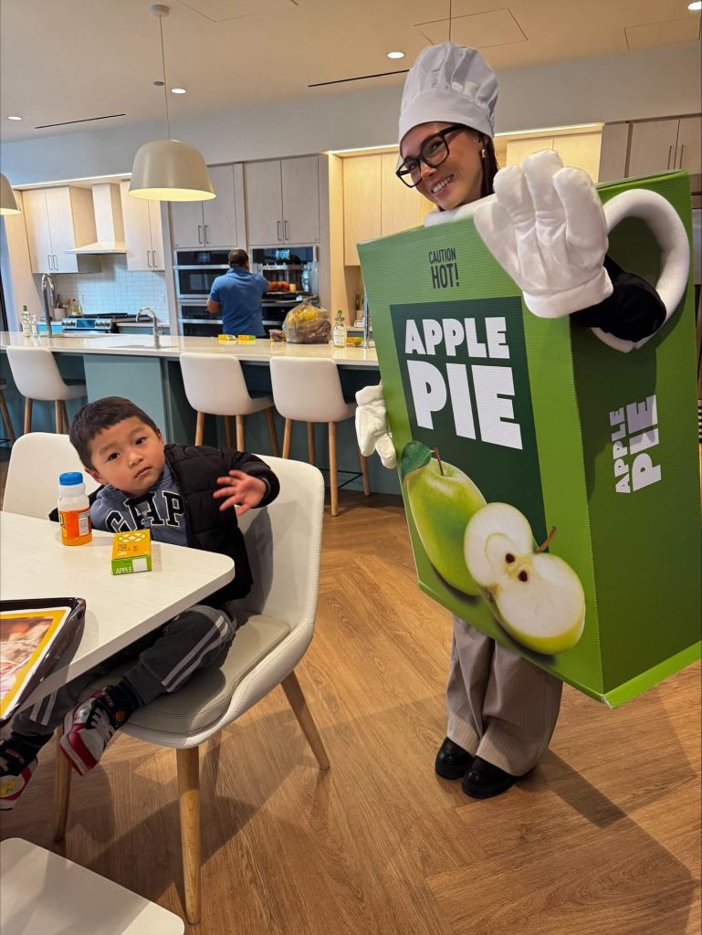 CartonCraft team member in apple pie costume with Ronald McDonald House child guest on Pi Day