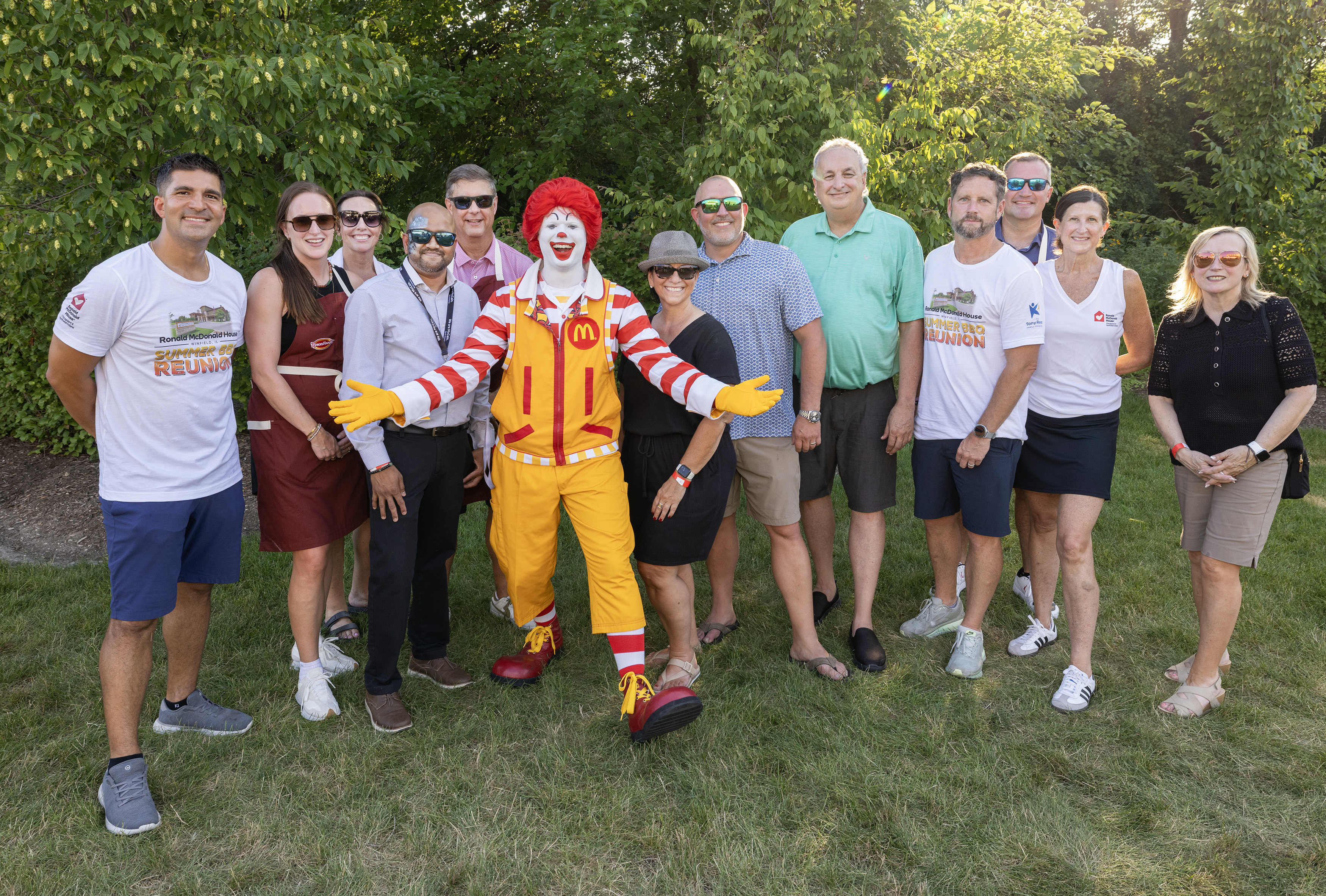 Sponsors and partners of the Ronald McDonald House Summer BBQ Reunion in Winfield, IL, including CartonCraft, posing with Ronald McDonald.