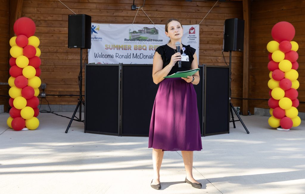 Northwestern Medicine Central DuPage Hospital leadership welcome families on stage at the Ronald McDonald House Summer BBQ Reunion.